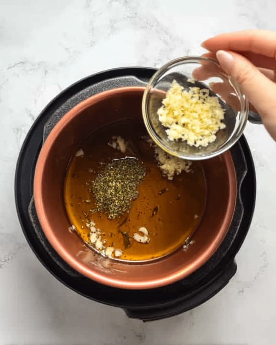 A clear glass bowl sits on a white marbled surface, filled with several pieces of raw chicken coated in a thick, orange marinade. The chicken pieces are uneven in size and color, ranging from golden yellow to rich orange with smooth, wet textures from the sauce covering them. The marinade appears creamy and clings to the chicken, giving a glossy look. The bowl is partially filled, showing some clear glass at the edges, and the chicken pieces are piled casually inside. Photo taken with an iphone --ar 4:5 --v 7