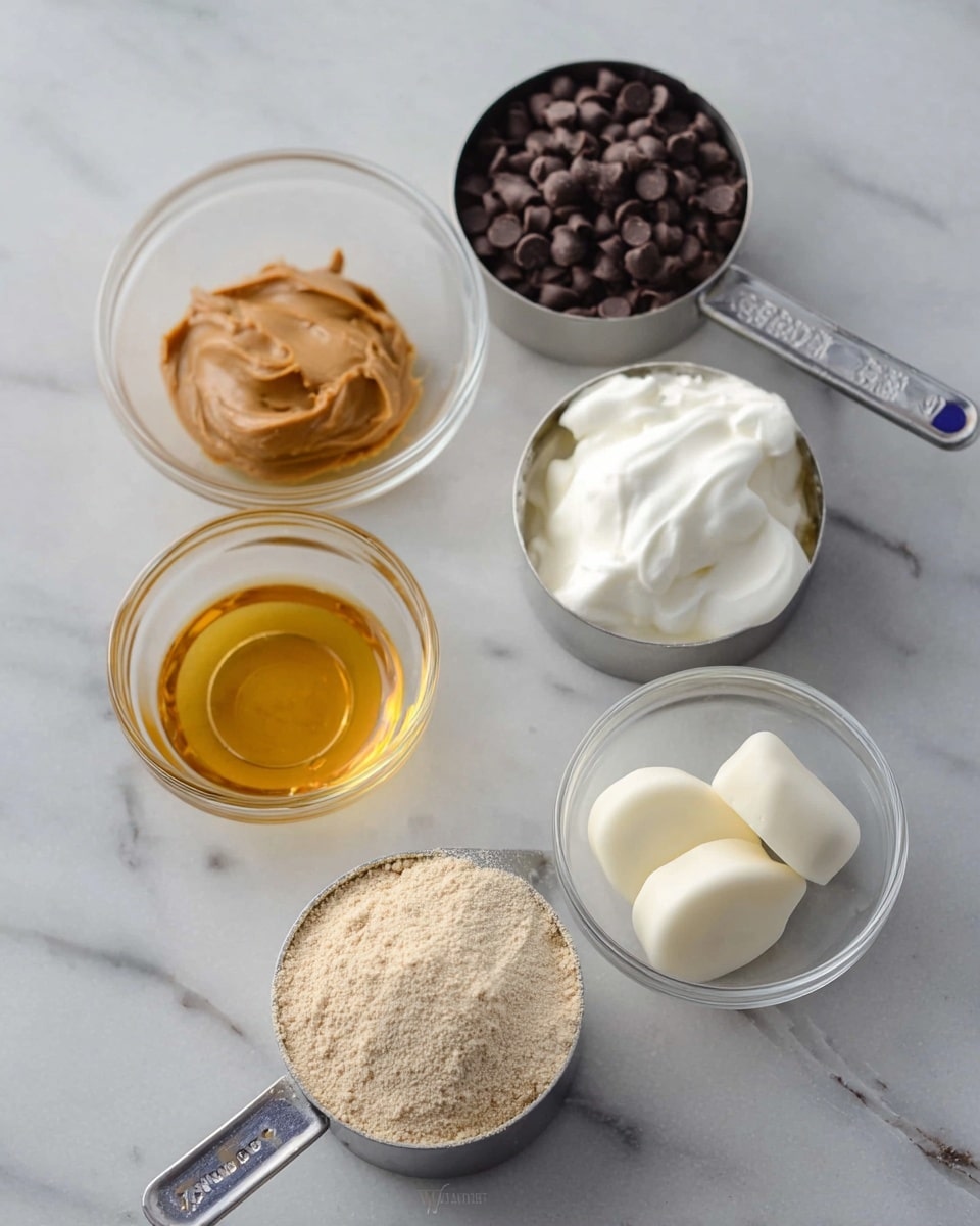The image shows several round dough balls arranged closely on a white marbled surface. Each ball has a smooth light beige base layer with dark brown chocolate chips scattered on top, some chips standing upright while others lay flat. Thin dark brown chocolate drizzle runs over the tops and sides of the dough balls. A few light beige peanut pieces are placed near the center tops of some dough balls, adding extra detail. The overall look is soft and creamy with a mix of smooth and slightly textured surfaces, focused tightly on the front dough ball. Photo taken with an iphone --ar 4:5 --v 7
