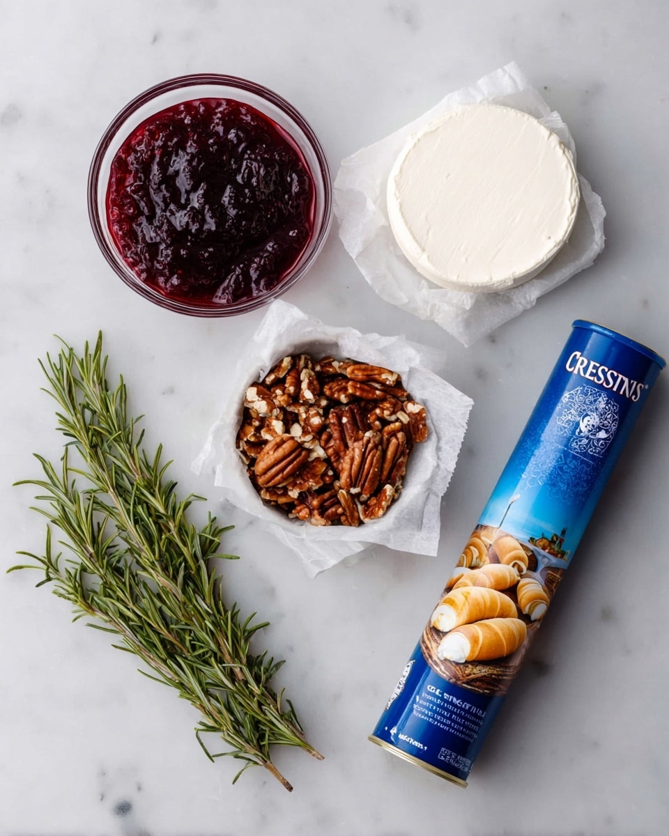 The image shows five items arranged on a white marbled surface: a small glass bowl filled with dark red, thick jam with a shiny texture; next to it, a white round piece of cream cheese wrapped in white paper; a small white bowl filled with chopped brown pecans; a blue cylindrical tube of crescent rolls with an image of golden crescent rolls on it; and three green sprigs of rosemary with needle-like leaves, placed in a small bundle. photo taken with an iphone --ar 4:5 --v 7