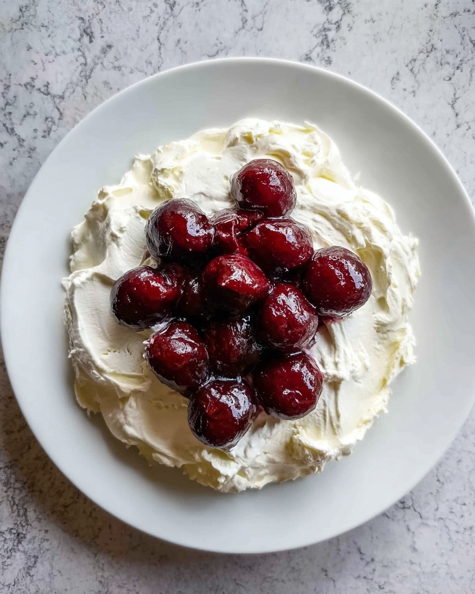 The dish shows about eight dark purple roasted round beets piled in the center on top of a thick white creamy layer spread in a rough circle shape on a white plate. The creamy layer has a slightly uneven texture with small bits of green herbs mixed in. The beets are sprinkled with white sesame seeds and fresh small green dill leaves. Around the cream, there is a light sprinkle of crushed nuts or seeds adding a tan crunchy texture. A little olive oil shines on the cream, giving a slight yellowish tint here and there. The plate sits on a white marbled surface. photo taken with an iphone --ar 4:5 --v 7