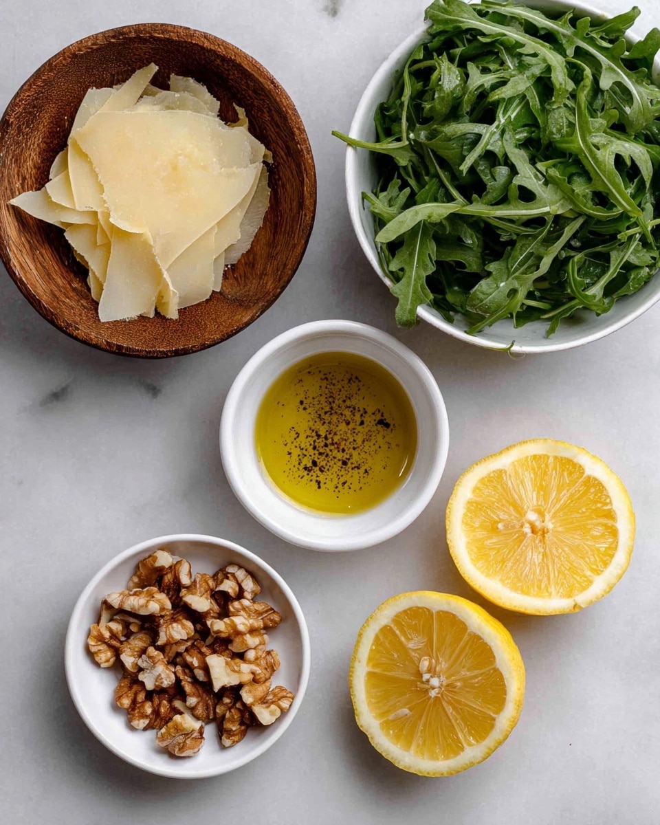 The image shows five items placed on a white marbled surface. In the top left, there is a round wooden bowl filled with pale yellow, thinly shaved pieces of cheese. To the right, a white bowl is full of fresh, dark green leafy arugula. Below the wooden bowl is a small white bowl holding broken walnut pieces in brown shades with a rough texture. In the center is another small white bowl containing a clear golden liquid, likely olive oil, sprinkled with black pepper. On the right side, two halves of a bright yellow lemon are placed with visible juicy pulp inside. photo taken with an iphone --ar 4:5 --v 7