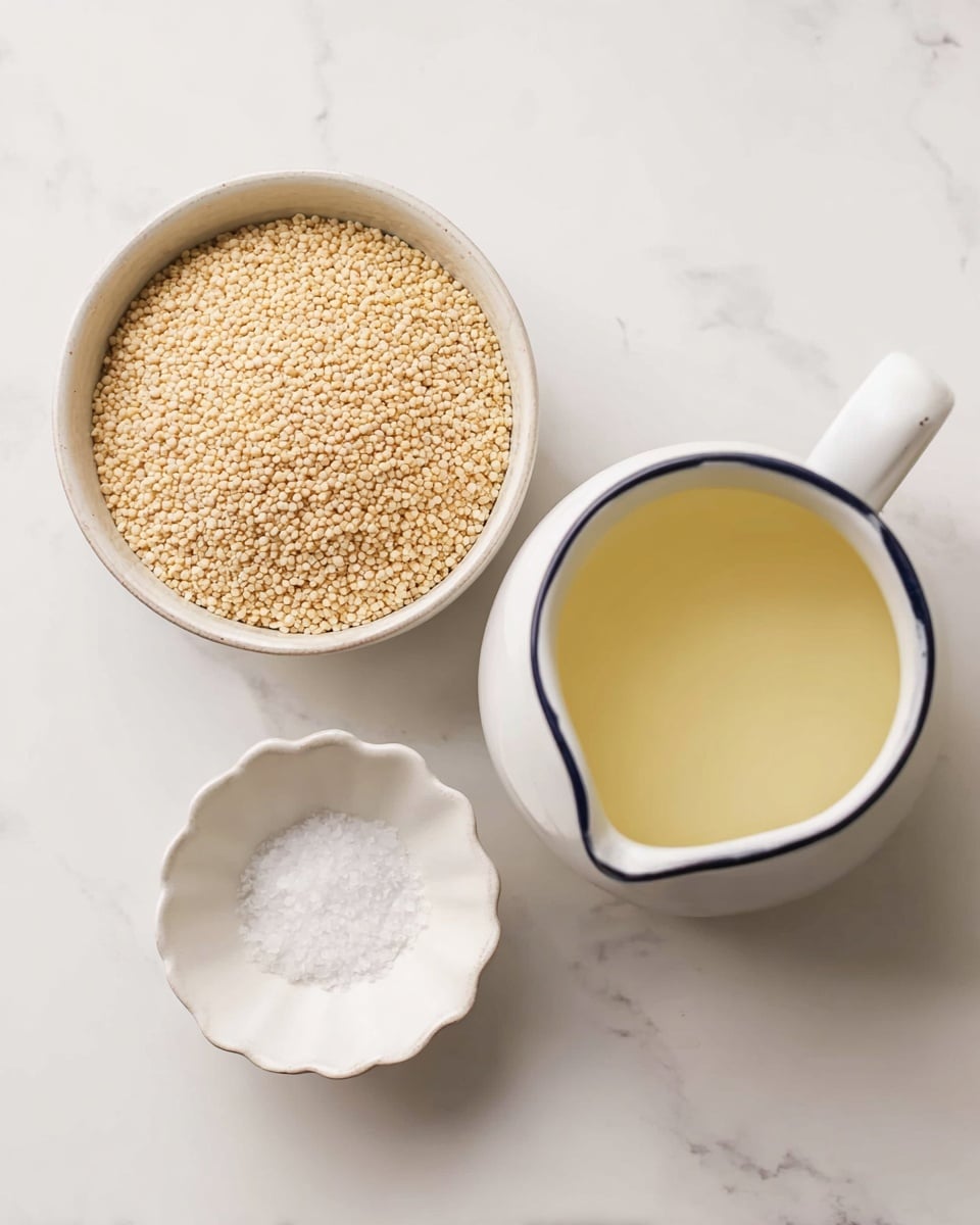 The image shows three white containers arranged on a white marbled surface. On the top left, there is a round bowl filled with small, light beige round grains. On the right, there is a white jug with a thin dark rim, filled to the brim with a clear, pale yellow liquid. At the bottom, there is a small white bowl with scalloped edges containing a small amount of white granulated salt, positioned slightly below the other two containers. The photo taken with an iphone --ar 4:5 --v 7