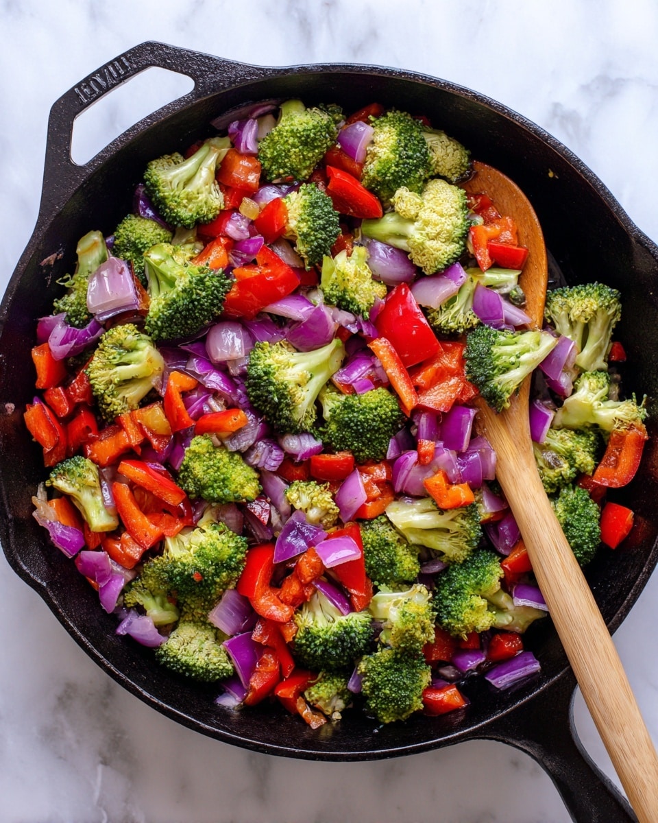 The image shows a black cast iron pan filled with three layers of cooked vegetables: bright green broccoli florets scattered throughout, red bell pepper pieces cut into medium chunks placed evenly, and small pieces of purple and white onion mixed in. A wooden spoon with a light brown handle rests inside the pan on top of the vegetables. The pan sits on a white marbled surface that provides a clean background. The colors are vivid, and the textures show a slight softness from cooking but retain freshness. Photo taken with an iphone --ar 4:5 --v 7