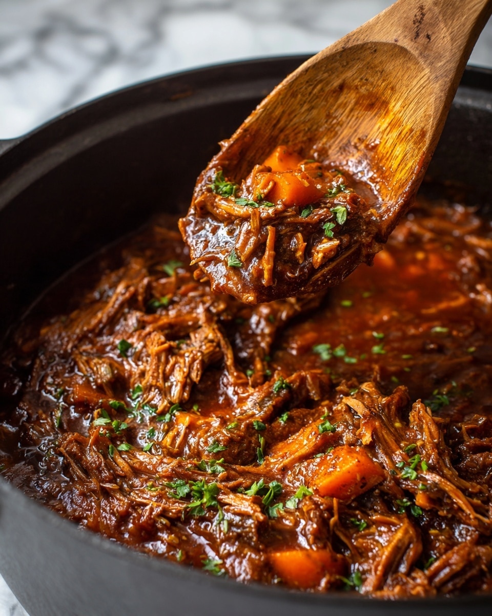 The image shows a close-up of a thick stew with shredded brown meat mixed with chunks of orange carrots, all covered in a rich, dark reddish-brown sauce. Small green herb leaves are scattered on top, adding a fresh touch. A wooden spoon is lifting a portion of the stew from a black pot, revealing the stew’s moist and tender texture. The background has a white marbled texture. photo taken with an iphone --ar 4:5 --v 7