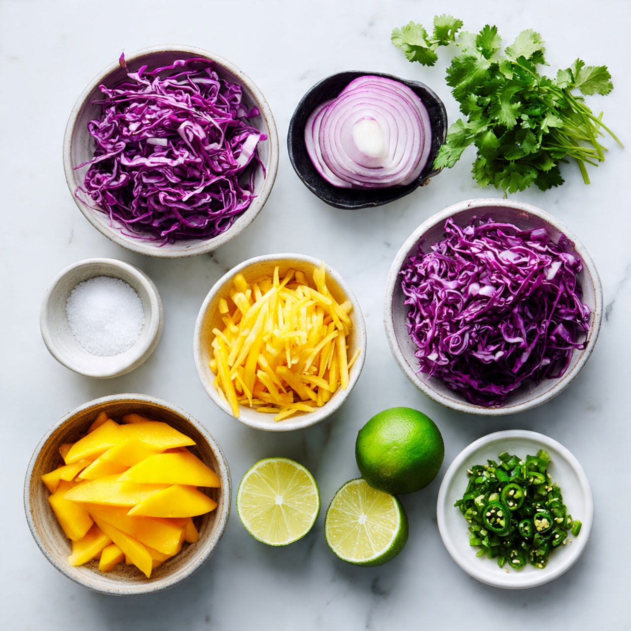 A white bowl filled with a colorful slaw salad showing several layers of thinly sliced vegetables: orange carrots, purple cabbage, light green cabbage, and green chopped herbs mixed together tightly, creating a bright and fresh look. Two halved limes with light green skin sit on one side inside the bowl. Two shiny metal spoons rest on the sides of the bowl, one partially submerged in the salad, reflecting some of the colors. The bowl is placed on a white marbled surface. Photo taken with an iphone --ar 4:5 --v 7