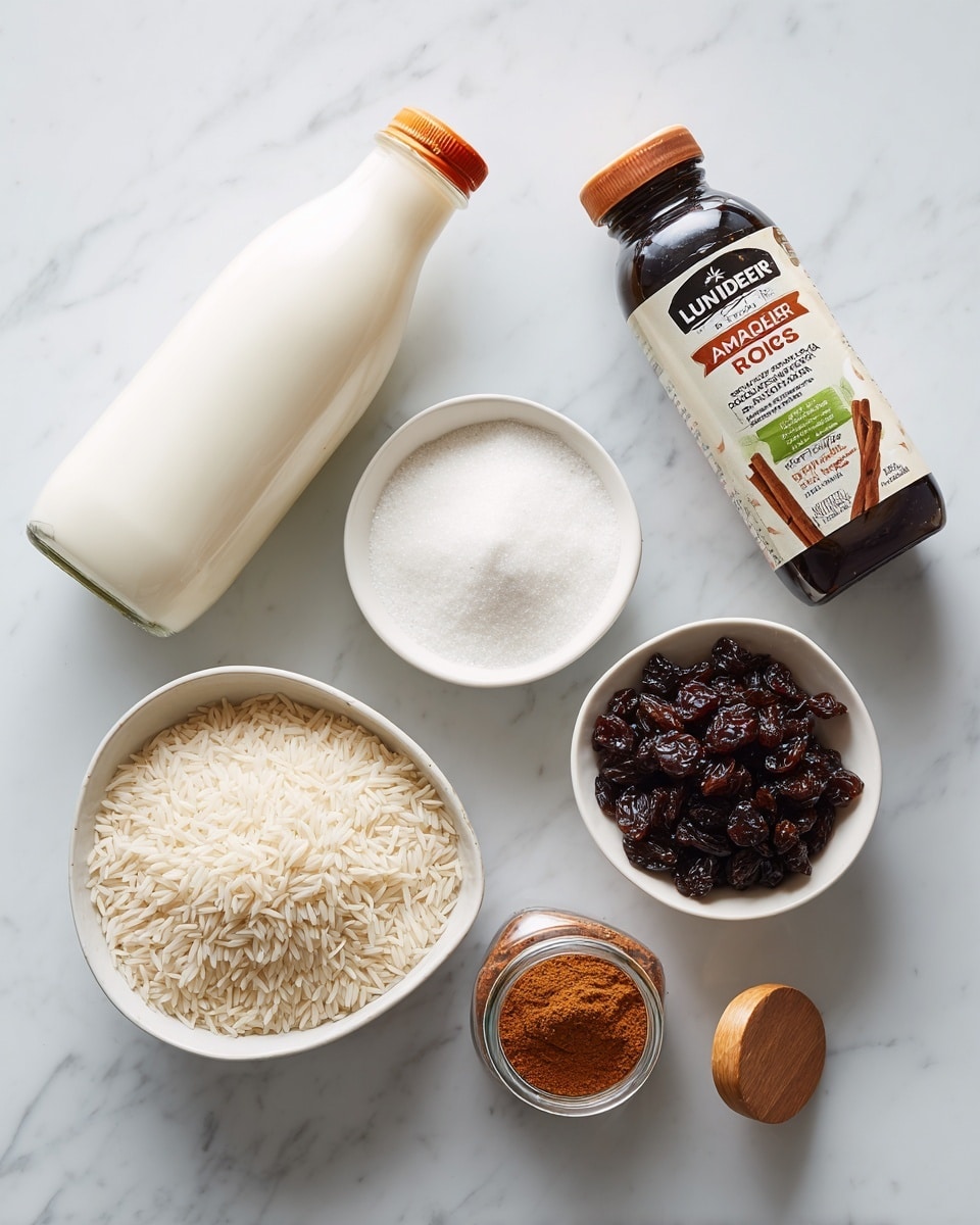 The image shows a white marbled surface holding several ingredients arranged neatly. On the top left, there is a clear plastic bottle of whole milk with a white and orange label. Next to it on the right is a green bag of Lundberg white Arborio rice with white text. Below these, there are three white bowls placed in a loose triangular shape: the top bowl contains white granulated sugar, the lower left bowl holds a creamy white substance, possibly cream or yogurt, and the lower right bowl is filled with dark brown raisins. Between the bowls of sugar and raisins, there are two small containers: a dark glass bottle labeled Madagascar vanilla bean paste with a red and white label, and a clear glass jar of ground cinnamon with an orange-brown powder and a wooden lid, labeled cinnamon. The overall scene is clean and simple with a light, neutral background. photo taken with an iphone --ar 4:5 --v 7