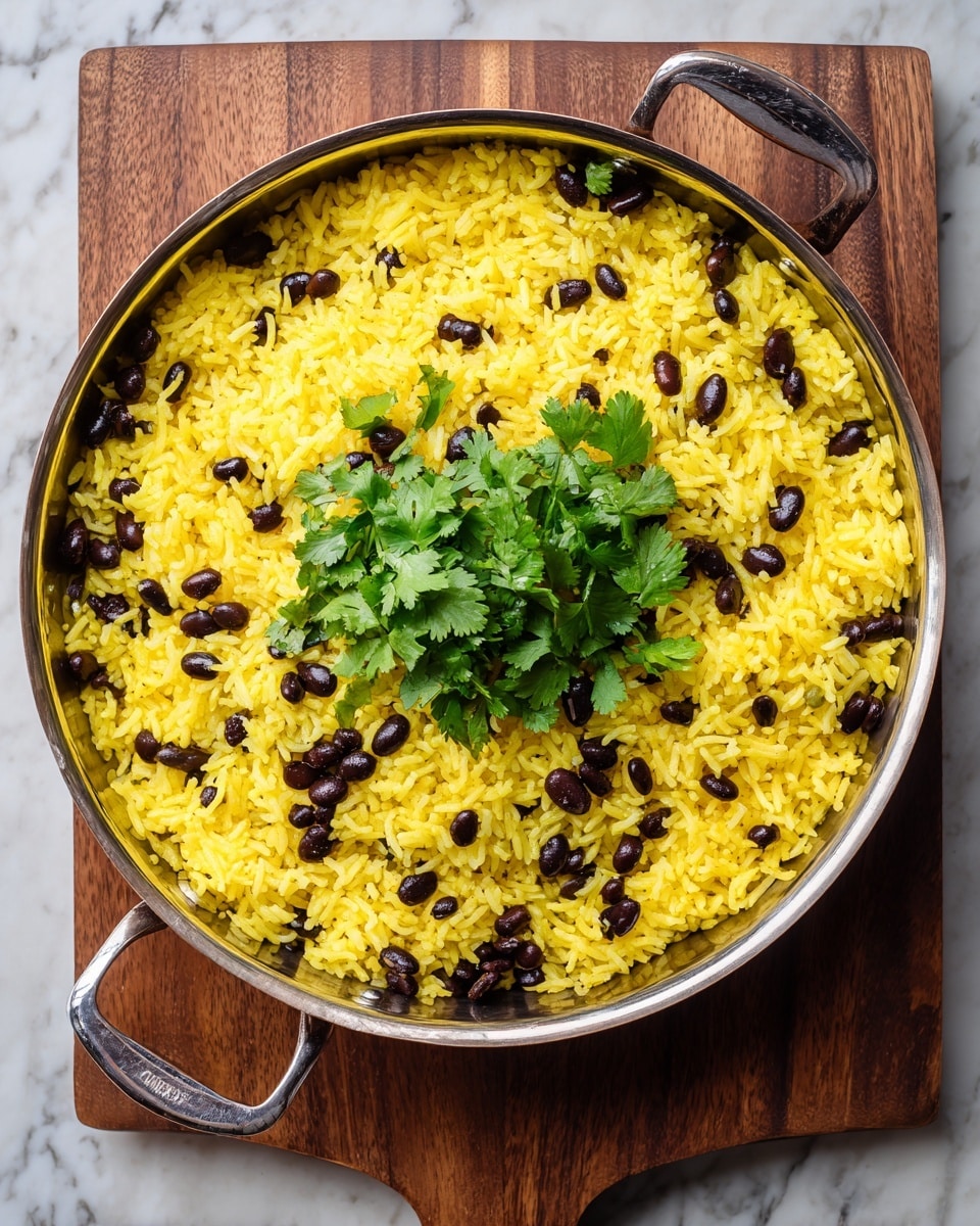 A metal pan filled with three main layers: the bottom layer is fluffy yellow rice covering the entire pan, the middle layer consists of scattered black beans spread evenly over the rice, and the top layer is a bunch of fresh green cilantro leaves placed in the center. The pan is on a wooden board background, which should be changed to a white marbled texture. The scene is bright and clear, showing the different textures of the rice, beans, and cilantro clearly. photo taken with an iphone --ar 4:5 --v 7