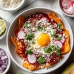 Creamy Guajillo Chilaquiles with Fried Eggs and Fresh Toppings Recipe