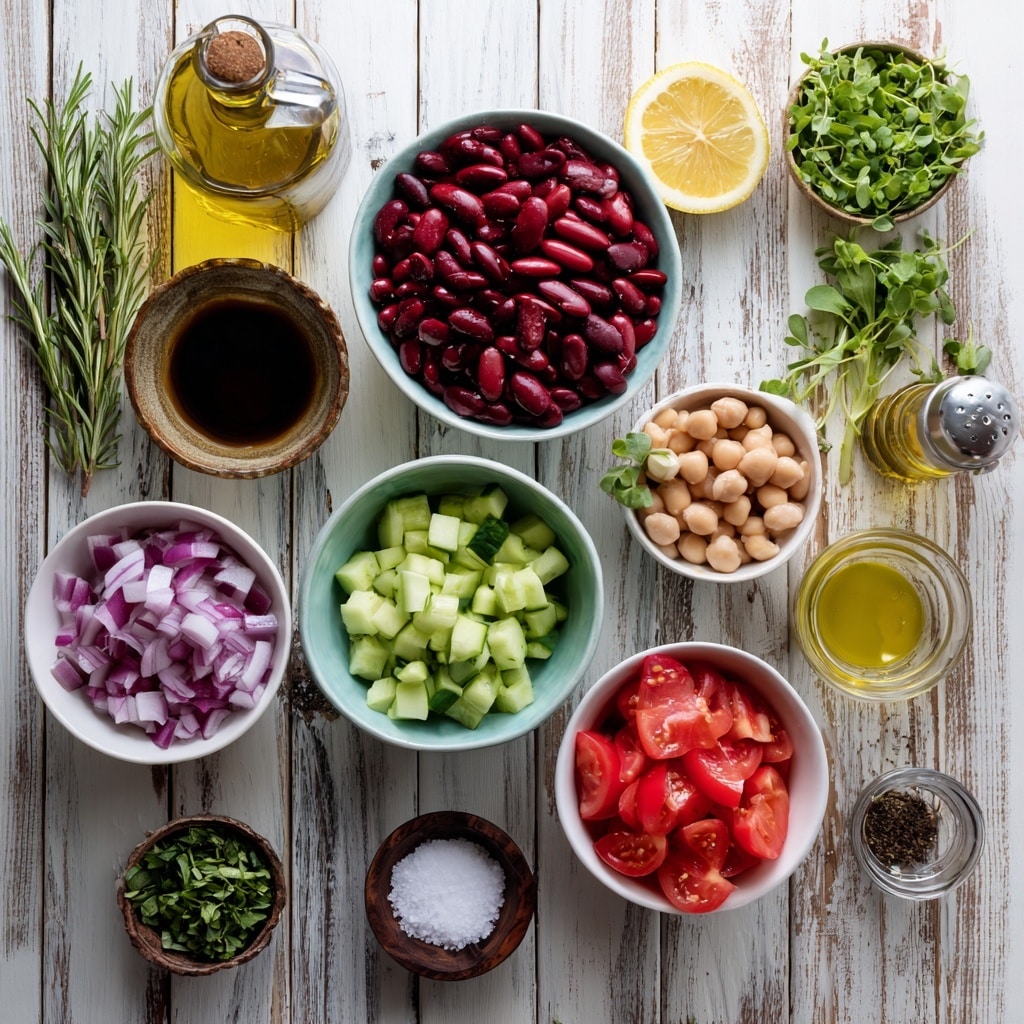 A clear glass bowl filled with six sections of chopped salad ingredients arranged in a circle. Starting at the top and moving clockwise, the first section contains pale white beans, followed by bright green chopped celery, then round beige chickpeas, light green chopped cucumber, dark red kidney beans, and finely chopped pale red onion. In the center of the bowl is a small pile of finely chopped red bell pepper. The bowl sits on a white marbled surface with a wooden spoon and a grey cloth nearby. Photo taken with an iphone --ar 4:5 --v 7