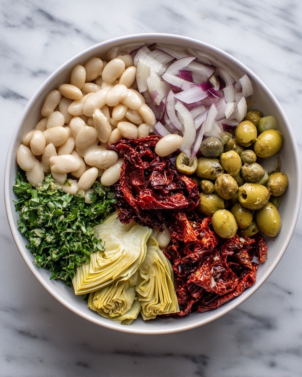 The image shows a white bowl filled with six separate layers of ingredients arranged in sections. Starting from the top left, there are light beige white beans, next to thinly sliced pale purple shallots or onions. To the right, small green capers sit closely packed. Below the capers are bright green sliced olives, next to pale yellow artichoke hearts placed neatly. Finally, at the bottom left, there is chopped fresh dark green parsley. In the center of the bowl, there is a small pile of deep red sun-dried tomatoes that add a bold color contrast to the mix. The bowl sits on a white marbled surface. photo taken with an iphone --ar 4:5 --v 7