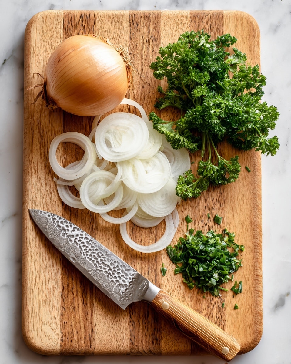 A wooden cutting board with a light tan and medium brown wood pattern sits on a white marbled surface. On the board, there is one whole light brown onion placed near the top left corner. Below it, several thin white onion rings with smooth texture are stacked loosely. To the right of the onion slices, there is a bunch of fresh green parsley with leafy, curly edges. In front of the parsley, finely chopped parsley leaves are scattered in a small heap. A kitchen knife with a silver blade that has a hammered pattern and a wooden handle rests diagonally on the bottom left corner of the cutting board. photo taken with an iphone --ar 4:5 --v 7