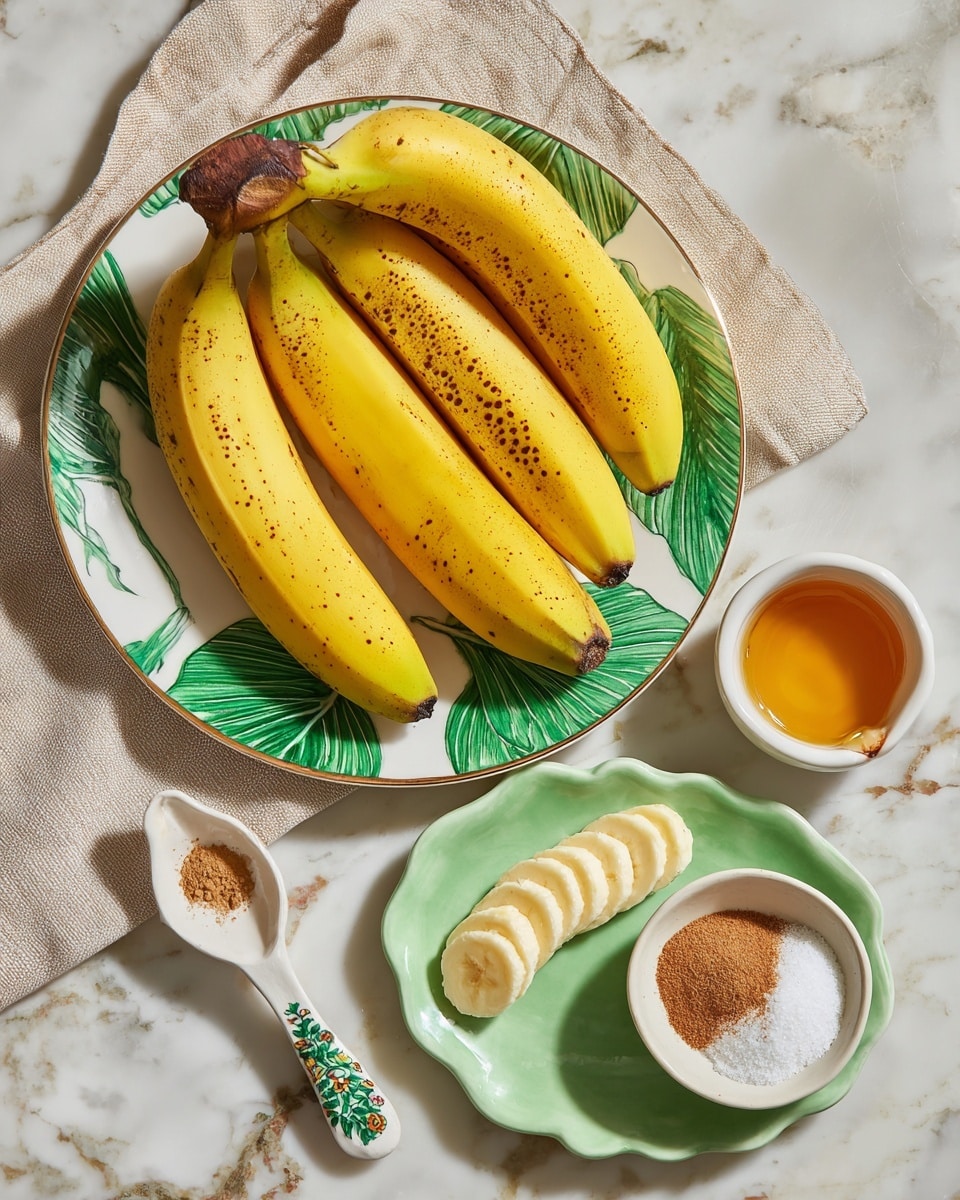 A bunch of five bright yellow bananas with small brown spots is placed on a white plate with green leaf patterns, partially covered by a beige cloth. Below, on a white marbled surface, sits a light green scalloped plate holding sliced yellow butter arranged in a line on one side and a small green bowl containing white sugar and brown cinnamon powder on the other side. To the left of the green plate is a small white spoon with a green and brown decorated handle, and above the spoon, a small white cup contains golden honey. photo taken with an iphone --ar 4:5 --v 7