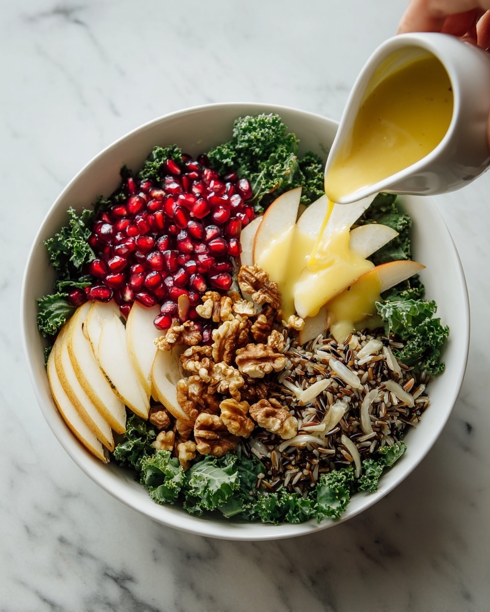 A white bowl holds a fresh salad with four main layers. The bottom layer is bright green kale leaves, curly and full. On top of that, there are pomegranate seeds on one side, showing their shiny red color. Next to the pomegranate, there is a mix of wild rice with light brown and black grains. On another side, there are thin slices of pale yellow pear. Scattered among these are pieces of light brown walnuts. A woman's hand pours a golden yellow dressing over the salad from a small white container. The bowl sits on a white marbled surface. Photo taken with an iphone --ar 4:5 --v 7