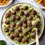 Herby Meatballs with Roasted Garlic Whipped Feta and Caper-olive Topping Recipe