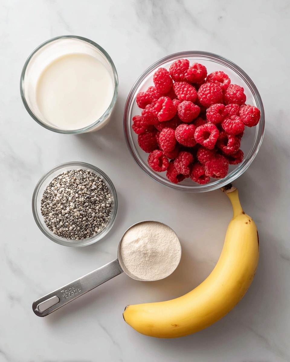 The image shows five separate ingredients arranged on a white marbled surface: a clear glass cup filled with a creamy white liquid at the top left, a clear glass bowl full of bright red raspberries at the top right, a metal measuring cup holding small gray and white seeds near the center right, a plastic scoop with a pale beige powder below the seeds, and a peeled yellow banana placed diagonally at the bottom right. The arrangement is simple and clean with good lighting and no shadows photo taken with an iphone --ar 4:5 --v 7