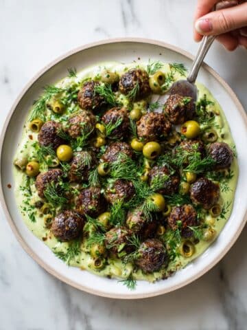 Herby Meatballs with Roasted Garlic Whipped Feta and Caper Olive Topping Recipe