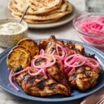 Grilled Chicken Thighs with Sumac, Pickled Onions, and Charred Lemon Recipe
