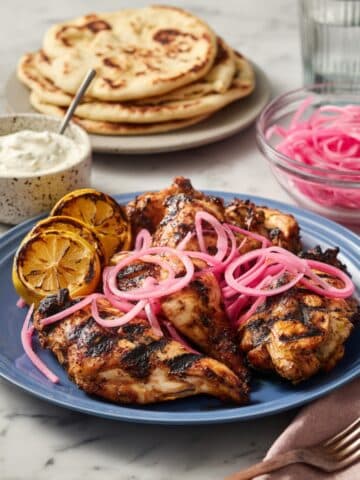Grilled Chicken Thighs with Sumac, Pickled Onions, and Charred Lemon Recipe