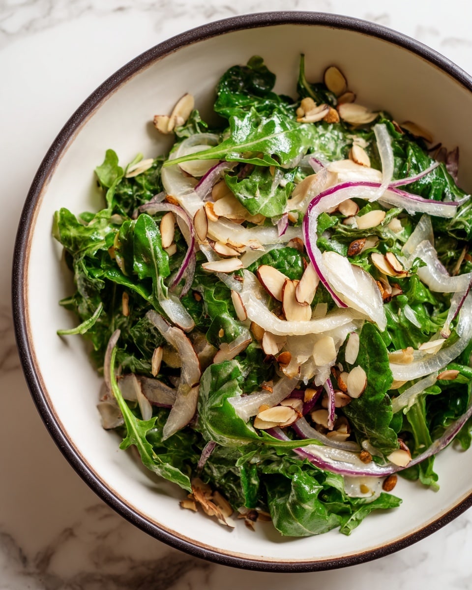 A white bowl with a dark rim holds a salad made mainly of dark green arugula leaves at the base. Thin slices of pale white fennel are spread evenly on top, mixed with thin slices of light purple onion, adding a touch of color. Light brown almond slices are scattered all over the salad, giving it a crunchy look. The bowl is placed on a white marbled surface. photo taken with an iphone --ar 4:5 --v 7
